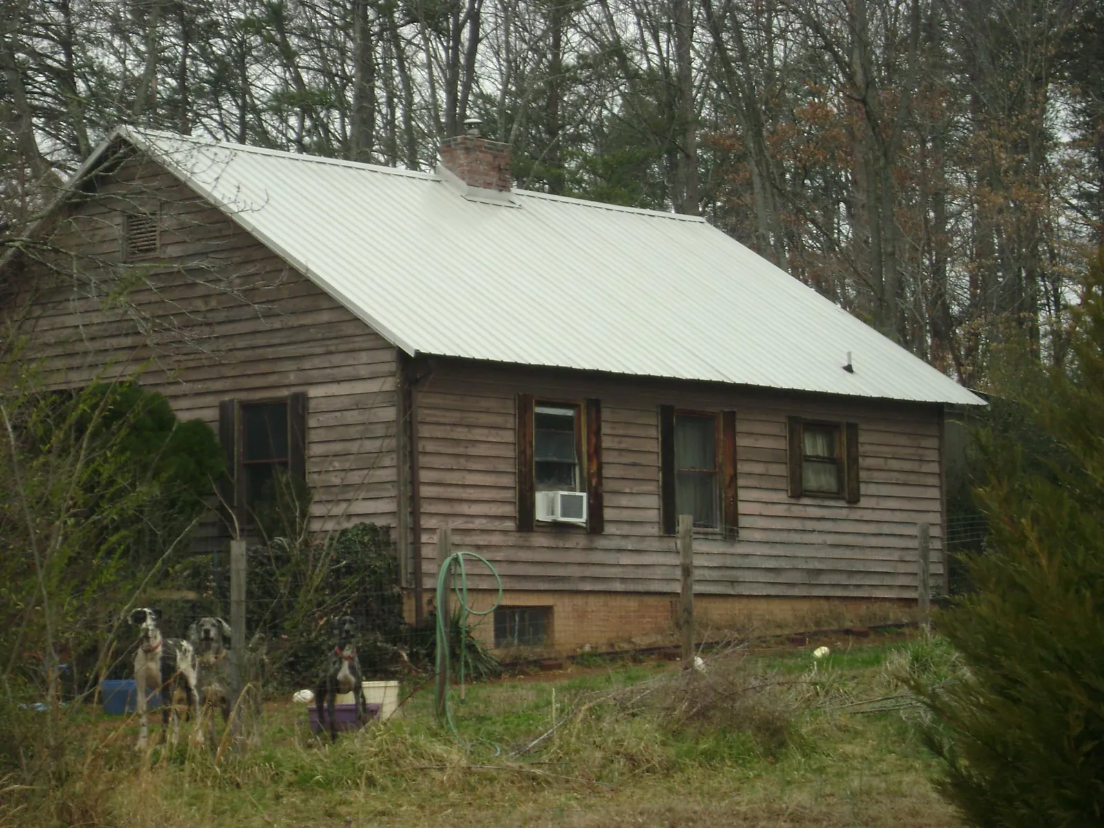 White metal roof on an old wood sided farmhouse, from a Metal Roof Installation job in Bloomingburg